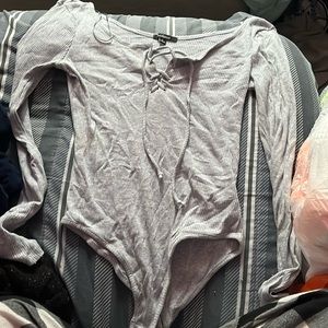 grey shirt, long sleeves, off the shoulder, ties by the chest